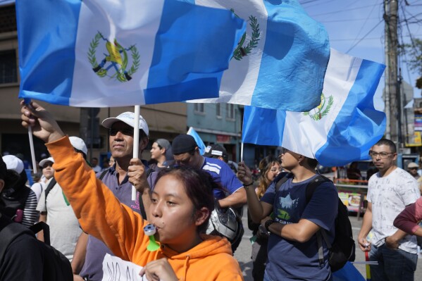 Demonstrators protest in front of Guatemala's Attorney General's office building in Guatemala City, Thursday, July 13, 2023. The Attorney General's Office announced on July 12 that a judge had suspended the legal status of the Seed Movement political party for alleged violations when it gathered the necessary signatures to form. The party's presidential candidate had been set to compete in a runoff election on Aug. 20. (AP Photo/Moises Castillo)