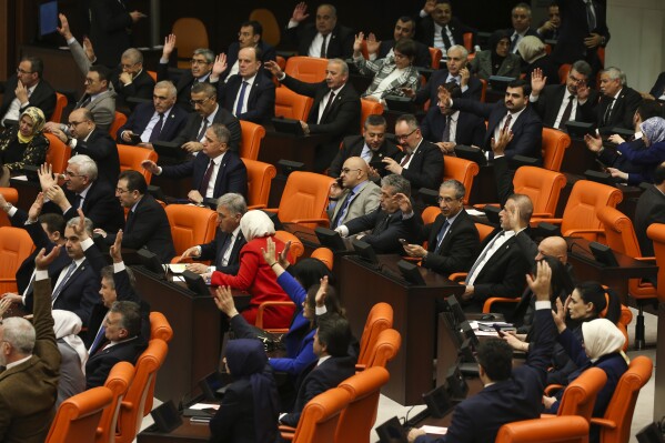 Turkish lawmakers vote in favor of Sweden's bid to join NATO at the Turkish Parliament in Ankara, Turkey, Tuesday, Jan. 23, 2024. Turkish legislators on Tuesday endorsed Sweden's membership in NATO, lifting a major hurdle on the previously nonaligned country's entry into the military alliance. (AP Photo/Ali Unal)