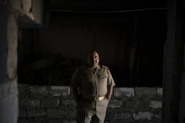 
              In this April 9, 2019 photo, Iraqi army 20th division Maj. Khalid Abdullah Baidar al-Jabouri poses for a portrait in Badoush, Iraq. His battalion is based in the area as a peacekeeping force, setting up checkpoints and carrying out raids to identify and arrest remaining Islamic State militants. "The operations that we do now rely on intelligence by following up the families of Daesh," he said, using the Arabic acronym for the group. (AP Photo/Felipe Dana)
            