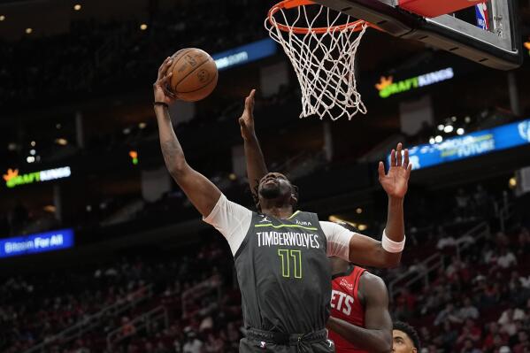 Minnesota Timberwolves' Naz Reid (11) shoots against the Houston Rockets during the first half of an NBA basketball game Sunday, Jan. 8, 2023, in Houston. (AP Photo/David J. Phillip)