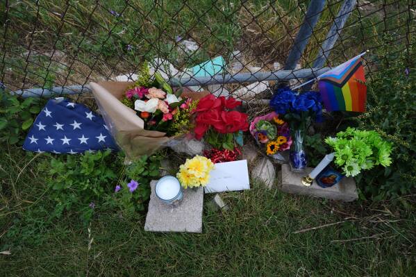 Candles, flowers and memos for voice actor Jonathan Joss, who was recently killed in San Antonio on Tuesday, June 3, 2025, constitute the Makeshift Memorial. (AP Photo/Eric Gay)