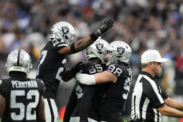 Las Vegas Raiders defensive end Chandler Jones (55) celebrates his sack with defensive end Maxx Crosby (98) and cornerback Sam Webb (27) during the first half of an NFL football game against the Los Angeles Chargers, Sunday, Dec. 4, 2022, in Las Vegas. (AP Photo/Matt York)