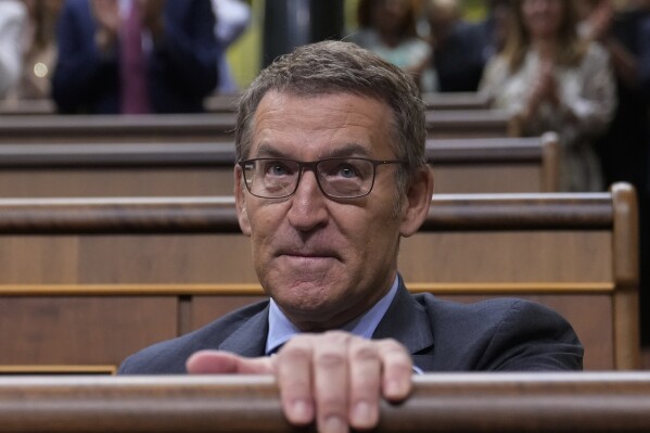 Alberto Nunez Feijoo takes his seat during an investiture session at the Spanish parliament in Madrid, Spain, Wednesday, Sept. 27, 2023. The leader of Spain's conservatives Alberto Feijoo faces the first of two investiture votes, Wednesday, that will determine whether he can become prime minister. Spain's July 23 national election gave Feijoo's Popular Party the most seats in the parliament's 350-member lower chamber but well shy of an absolute majority. (AP Photo/Paul White)