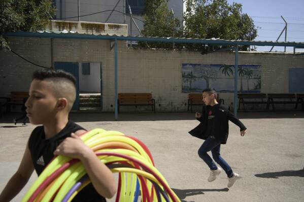 Students participate in physical education at the UNRWA Boys' School run by the U.N. agency for Palestinian refugees in the Shuafat Refugee Camp in east Jerusalem, Tuesday, April 29, 2025. (AP Photo/Maya Alleruzzo)