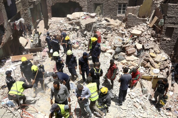 Rescuers search through the rubble of a collapsed five-story apartment building in Cairo, Egypt, Monday, July 17, 2023. A five-story apartment building collapsed Monday in the Egyptian capital of Cairo, leaving several people dead, authorities said, as rescuers at the scene searched through the rubble. Building collapses are common in Egypt, where shoddy construction and a lack of maintenance are widespread in shantytowns, poor city neighborhoods and rural areas. (AP Photo)