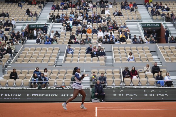 Empty seats in center court Philippe Chatrier are seen as Coco Gauff of the U.S. plays a shot against Italy's Elisabetta Cocciaretto during their fourth round match of the French Open tennis tournament at the Roland Garros stadium in Paris, Sunday, June 2, 2024. (AP Photo/Thibault Camus)