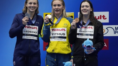 Gold medallist Ariarne Titmus of Australia, center, is flanked by silver medallist Katie Ledecky of the United States, and bronze medallist Erika Fairweather of New Zealand as they pose with their medals after winning Women 400m Freestyle finals at the World Swimming Championships in Fukuoka, Japan, Sunday, July 23, 2023. (AP Photo/Lee Jin-man)