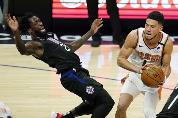 Los Angeles Clippers guard Patrick Beverley, left, falls back while defending on Phoenix Suns guard Devin Booker during the first half of an NBA basketball game Thursday, April 8, 2021, in Los Angeles. (AP Photo/Marcio Jose Sanchez)