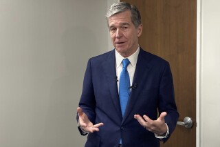 North Carolina Democratic Gov. Roy Cooper speaks to reporters after a Council of State meeting at the state transportation building in Raleigh, N.C., on Tuesday, Sept. 12, 2023. Cooper spoke about delays in the state budget that can now be attributed to a standoff between House and Senate Republicans over whether to insert gambling expansion provisions within the legislation. (AP Photo/Gary D. Robertson)