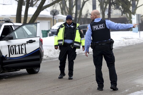 Joliet police officers work at the scene where multiple people were shot , Tuesday, Jan. 23, 2024, to death. A man suspected of shooting and killing eight people in suburban Chicago fatally shot himself after a confrontation with law enforcement officials at a gas station in Texas, where he had no known ties, authorities said. (Antonio Perez /Chicago Tribune via AP)