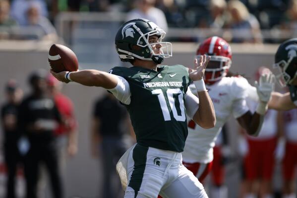Michigan State quarterback Payton Thorne throws a 75-yard touchdown pass off a flea-flicker on the first play from scrimmage against Youngstown State in the first quarter of an NCAA college football game, Saturday, Sept. 11, 2021, in East Lansing, Mich. (AP Photo/Al Goldis)