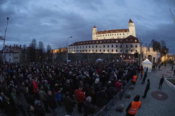 People gather to take part in a protest against a government plan to amend the penal code, in front of the National Council of the Slovak Republic in Bratislava, Wednesday, Feb. 7, 2024. (Michal Svitok/TASR via AP)