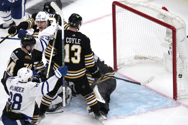 Toronto Maple Leafs left wing Matthew Knies (23) celebrates after his game-winning goal on Boston Bruins goaltender Jeremy Swayman (1) during overtime of Game 5 of an NHL hockey Stanley Cup first-round playoff series, Tuesday, April 30, 2024, in Boston. (AP Photo/Charles Krupa)