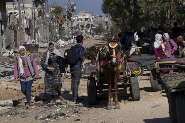 Palestinians flee to the southern Gaza Strip along Salah al-Din Street, on the outskirts of Gaza City, during the ongoing Israeli bombardment on Saturday, Nov. 18, 2023. (AP Photo/Adel Hana)