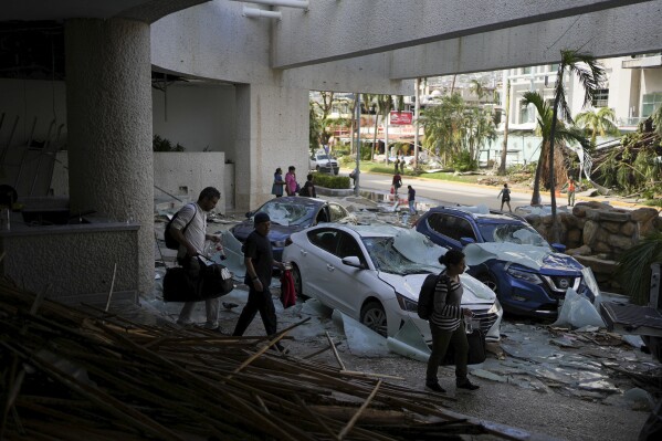 Damaged vehicles are parked covered by debris i the driveway of a hotel after Hurricane Otis ripped through Acapulco, Mexico, Thursday, Oct. 26, 2023. The hurricane that strengthened swiftly before slamming into the coast early Wednesday as a Category 5 storm has killed at least 27 people as it devastated Mexico’s resort city of Acapulco. (AP Photo/Felix Marquez)