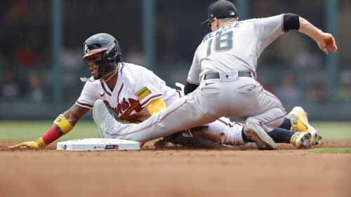 Atlanta Braves' Ronald Acuna Jr., left, steals second base against Miami Marlins shortstop Joey Wendle (18) during the first inning of a baseball game Sunday, July 2, 2023, in Atlanta. (AP Photo/Alex Slitz)
