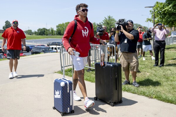 Kansas City Chiefs quarterback Patrick Mahomes wheels his belongings into a dorm room at Missouri Western State University during the first day of NFL football training camp on Tuesday, July 18, 2023, in St. Joseph, Mo. (Nick Wagner/The Kansas City Star via AP)