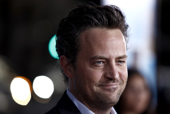 FILE - Matthew Perry arrives at the premiere of "The Invention of Lying" in Los Angeles on Monday, Sept. 21, 2009. Perry, who starred as Chandler Bing in the hit series “Friends,” has died. He was 54. The Emmy-nominated actor was found dead of an apparent drowning at his Los Angeles home on Saturday, according to the Los Angeles Times and celebrity website TMZ, which was the first to report the news. Both outlets cited unnamed sources confirming Perry’s death. His publicists and other representatives did not immediately return messages seeking comment. (AP Photo/Matt Sayles, File)