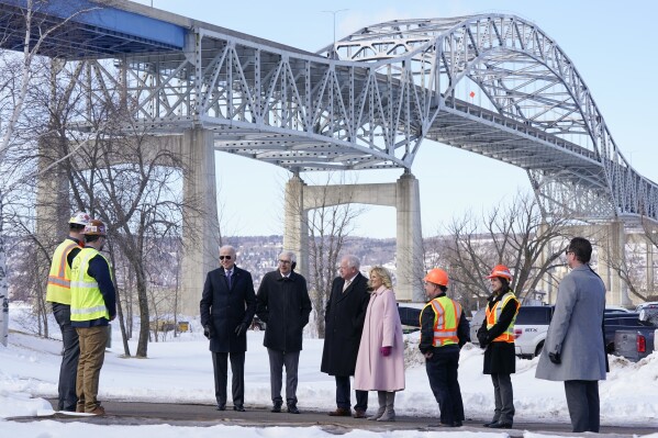 FILE - President Joe Biden and first lady Jill Biden visit the John A. Blatnik Memorial Bridge that connects Duluth, Minn., to Superior, Wis., March 2, 2022, in Superior, Wis. Biden is returning to the critical swing state of Wisconsin to announce nearly $5 billion in federal funding for upgrading the Blatnik Bridge and for dozens of similar infrastructure projects nationwide. (AP Photo/Patrick Semansky, File)