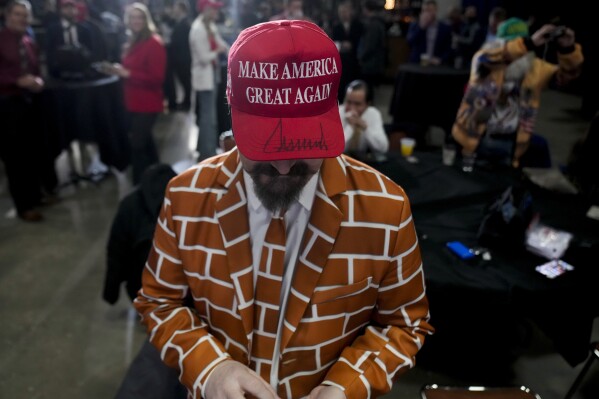 Supporters arrive before Republican presidential candidate former President Donald Trump speaks at a caucus night party in Des Moines, Iowa, Monday, Jan. 15, 2024. (AP Photo/Andrew Harnik)