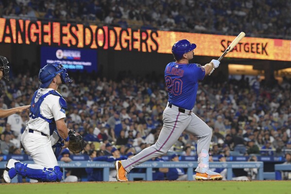 New York Mets' Pete Alonso, right, hits a three-run home run as Los Angeles Dodgers catcher Dalton Rushing watches during the eighth inning of a baseball game Wednesday, June 4, 2025, in Los Angeles. (AP Photo/Mark J. Terrill)