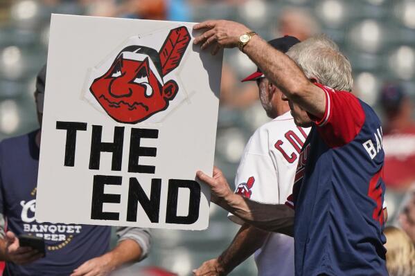 A Cleveland Indians fan holds up a sign during a baseball game between the Kansas City Royals and the Cleveland Indians, Monday, Sept. 27, 2021, in Cleveland. Cleveland plays its final home game against the Royals as the Indians, the team's nickname since 1915. The club will be called the Cleveland Guardians next season. (AP Photo/Tony Dejak)