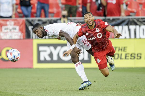 Toronto FC defender Justin Morrow (2) and New York Red Bulls midfielder Dru Yearwood (16) vie for the ball during the first half of an MLS soccer match Wednesday, July 21, 2021, in Toronto. (Chris Katsarov/The Canadian Press via AP)
