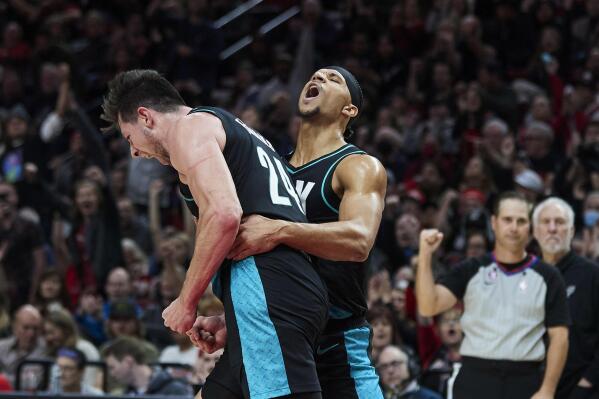 Portland Trail Blazers forward Drew Eubanks, left, and guard Josh Hart react after Eubanks scored a basket against the San Antonio Spurs during the second half of an NBA basketball game in Portland, Ore., Tuesday, Nov. 15, 2022. (AP Photo/Craig Mitchelldyer)