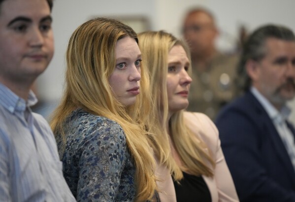 Taylor Edwards, left, and Kaitlyn Kash, who are plaintiffs in Zurawski v Texas, listen at the Texas Medical Board meeting to discuss guidance around physicians for medical exceptions to the state's abortion ban laws at the George H.W. Bush State Office Building in Austin, Texas, Friday March 22, 2024. (Jay Janner /Austin American-Statesman via AP)