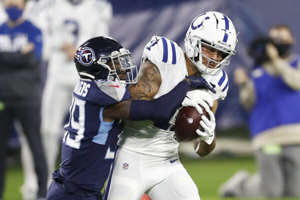 Indianapolis Colts wide receiver Michael Pittman (11) hangs onto a pass as he is defended by Tennessee Titans cornerback Breon Borders (39) in the first half of an NFL football game Thursday, Nov. 12, 2020, in Nashville, Tenn. (AP Photo/Wade Payne)