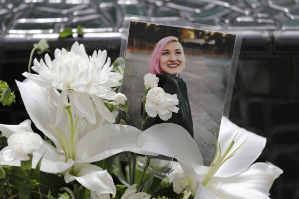 FILE - A photo of Summer Taylor, who suffered critical injuries and died after being hit by a car while protesting over the weekend, sits among flowers at the King County Correctional Facility where a hearing was held for the suspect in their death Monday, July 6, 2020, in Seattle. A man who hit two protesters, killing one of them, with his car during a Black Lives Matter demonstration in Seattle in 2020 has pleaded guilty to multiple felonies. The Seattle Times reports 30-year-old Dawit Kelete pleaded guilty on Thursday, July 27, 2023, to vehicular homicide in the death of Taylor. (AP Photo/Elaine Thompson, File)