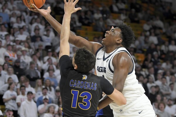 Utah State forward Great Osobor shoots the ball as San Jose State guard Alvaro Cardenas (13) defends during the first half of an NCAA college basketball game Tuesday, Jan. 30, 2024, in Logan, Utah. (Eli Lucero/Herald Journal via AP)