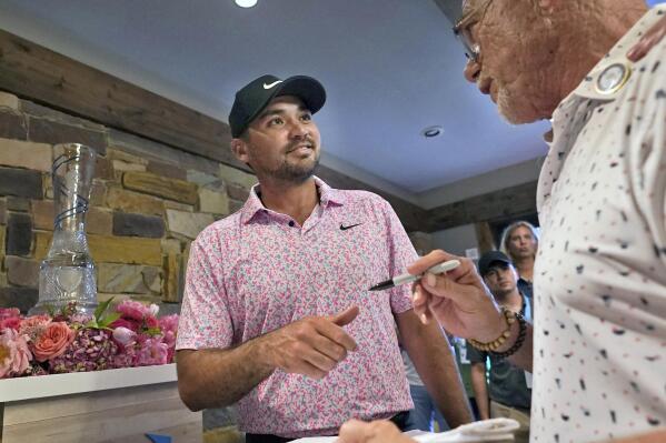 Jason Day, left,of Australia, is asked for an autograph by David Craig after winning the Byron Nelson golf tournament at Craig Ranch in McKinney, Texas, Sunday, May 14, 2023. (AP Photo/LM Otero)