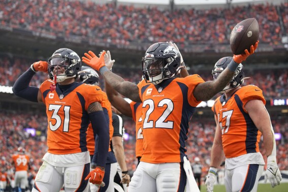 Denver Broncos safety Kareem Jackson (22) celebrates his interception against the Las Vegas Raiders with Broncos safety Justin Simmons (31) and Broncos linebacker Josey Jewell, right, during the second half of an NFL football game, Sunday, Sept. 10, 2023, in Denver. (AP Photo/David Zalubowski)
