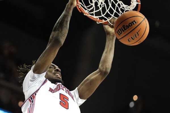 Houston forward Ja'Vier Francis dunks the ball during the second half of an NCAA college basketball game against Texas Tech in the semifinal round of the Big 12 Conference tournament, Friday, March 15, 2024, in Kansas City, Mo. Houston won 82-59. (AP Photo/Charlie Riedel)