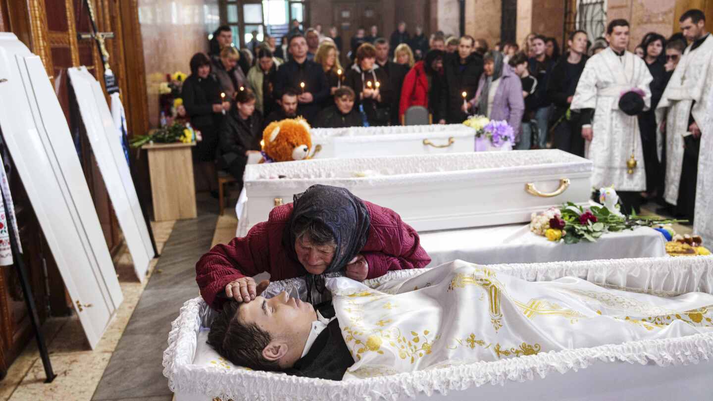 AP PHOTOS: 3 Ukrainian siblings buried after Russian missile strike