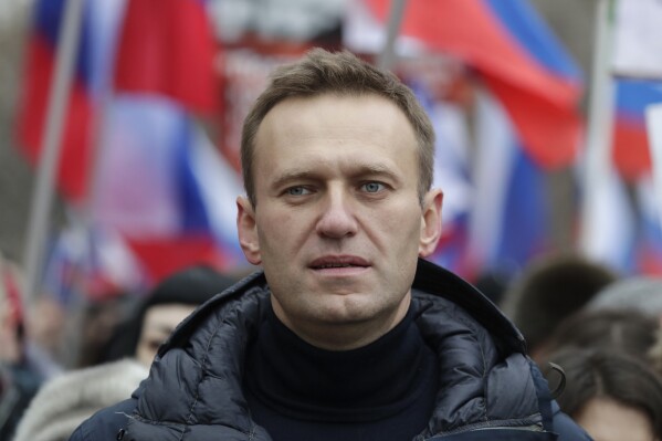 FILE - In this Sunday, Feb. 24, 2019 file photo, Russian opposition activist Alexei Navalny takes part in a march in memory of opposition leader Boris Nemtsov in Moscow, Russia. In August 2020, the opposition leader fell ill on a flight from Siberia to Moscow. The plane landed in the city of Omsk, where Navalny was hospitalized in a coma. Two days later, he was airlifted to Berlin, where he recovered. (AP Photo/Pavel Golovkin, File)