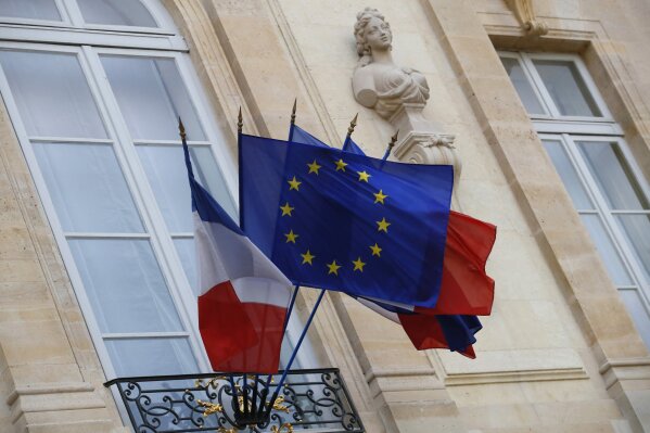 
              FILE - In this Monday, Dec. 10, 2018 file picture European and French flags are flapping at the Elysee Palace in Paris, during a meeting with French President Emmanuel Macron and local, national political leaders, unions, business leaders and others to hear their concerns after four weeks of protests. French Prime Minister Edouard Philippe announced Thursday that the government will start hiring 600 extra government employees including customs agents to handle cross-border trade and security. (AP Photo/Francois Mori, File)
            