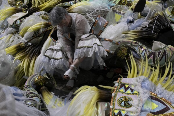 An artist prepares costumes ahead of Carnival celebrations at the Sambadrome in Rio de Janeiro, Monday, March 3, 2025. (AP Photo/Bruna Prado)