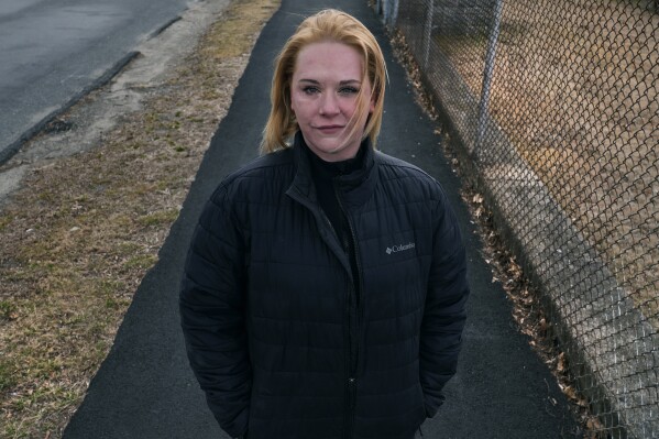 Maegan Ball stands for a portrait in Saugus, Mass., on Thursday, Feb. 29, 2024. In December 2018, police were requested to make a wellness check on a man by his mother. Officers found him severely beating Ball. Erich Stelzer, 25, who Ball met on a dating app, had beaten her face until bones shattered, stabbed her with a knife, gouged her eyes and tried to drive a wooden stake into her stomach. Two of the officers used their Tasers and managed to handcuff Stelzer as he thrashed on the floor. (AP Photo/Charles Krupa)