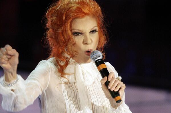FILE - In this Feb. 27, 2007 file photo, Italian singer  Maria Ilva Biolcati, knowns as Milva, performs "The show must go on" during the Sanremo Italian song contest, in San Remo, Italy. Milva, one of Italy's most popular singers in the ‘60s and ’70s, who had many fans abroad, has died at her home in Milan at the age of 81, Italy's culture minister announced Saturday, April 24, 2021.  (AP Photo/Luca Bruno, file)