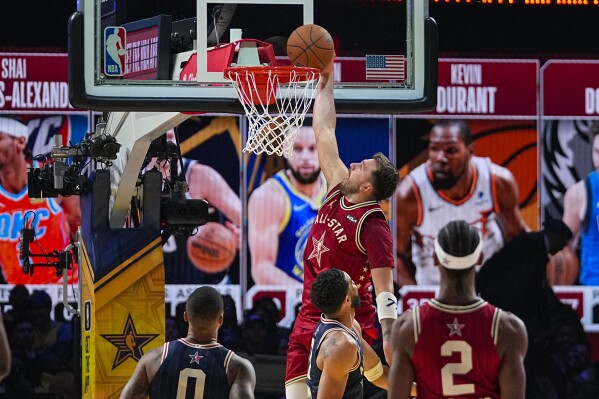 Dallas Mavericks guard Luka Doncic (77) get a basket on a dunk during the second half of an NBA All-Star basketball game in Indianapolis, Sunday, Feb. 18, 2024. (AP Photo/Darron Cummings)