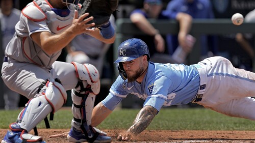 Kansas City Royals' Kyle Isbel slides home to score on a sacrifice fly hit by Bobby Witt Jr. during the fifth inning of a baseball game against the Los Angeles Dodgers Sunday, July 2, 2023, in Kansas City, Mo. (AP Photo/Charlie Riedel)
