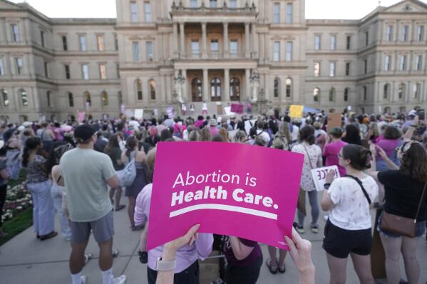 FILE - Abortion-rights protesters attend a rally following the United States Supreme Court's decision to overturn Roe v. Wade, the federally protected right to abortion, outside the state capitol in Lansing, Mich., Friday, June 24, 2022. The U.S. Supreme Court's decision striking down a constitutional right to abortion and sending the issue to the states has groups on both sides of the debate focusing more than ever on races this fall for state supreme courts. (AP Photo/Paul Sancya, File)