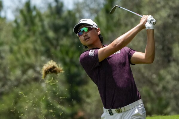 Australia's Min Woo Lee watches his shot into the seventh green during the second round of the Australian Open Golf Championship in Sydney, Australia, Friday, Dec. 1, 2023. (AP Photo/Mark Baker)