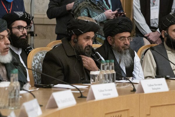 Taliban co-founder Mullah Abdul Ghani Baradar, center, with other members of the Taliban delegation attend an international peace conference in Moscow, Russia, Thursday, March 18, 2021. Russia is hosting a peace conference for Afghanistan, bringing together government representatives and their Taliban adversaries along with regional observers in a bid to help jump-start the country's stalled peace process. The one-day gathering Thursday is the first of three planned international conferences ahead of a May 1 deadline for the final withdrawal of U.S. and NATO troops from the country, a date fixed under a year-old agreement between the Trump administration and the Taliban. (AP Photo/Alexander Zemlianichenko, Pool)