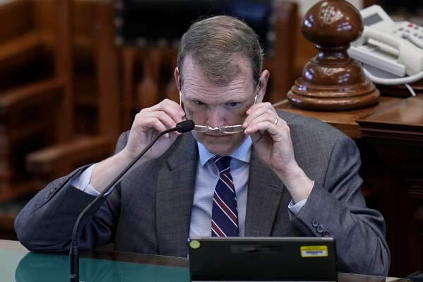 Witness Jeff Mateer reviews a document during the impeachment trial for Texas Attorney General Ken Paxton in the Senate Chamber at the Texas Capitol, Wednesday, Sept. 6, 2023, in Austin, Texas. (AP Photo/Eric Gay)