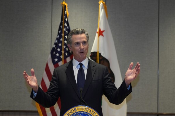 FILE - California Gov. Gavin Newsom speaks at a press conference in Beijing, Oct. 25, 2023. Newsom signed hundreds of new laws in 2023 that will take effect in California on Jan. 1, 2024. (AP Photo/Ng Han Guan,File)