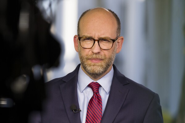 FILE - Acting director of Office of Management and Budget Russ Vought listens during a television interview at the White House, Oct. 21, 2019, in Washington. (AP Photo/Alex Brandon, File)