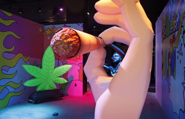 FILE - Gabe Williams works on an exhibit at the Cannabition cannabis museum in Las Vegas, Sept. 18, 2018. (AP Photo/John Locher, File)